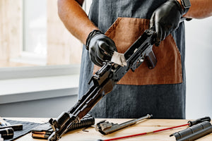 Person drying the inner mechanisms of a rifle